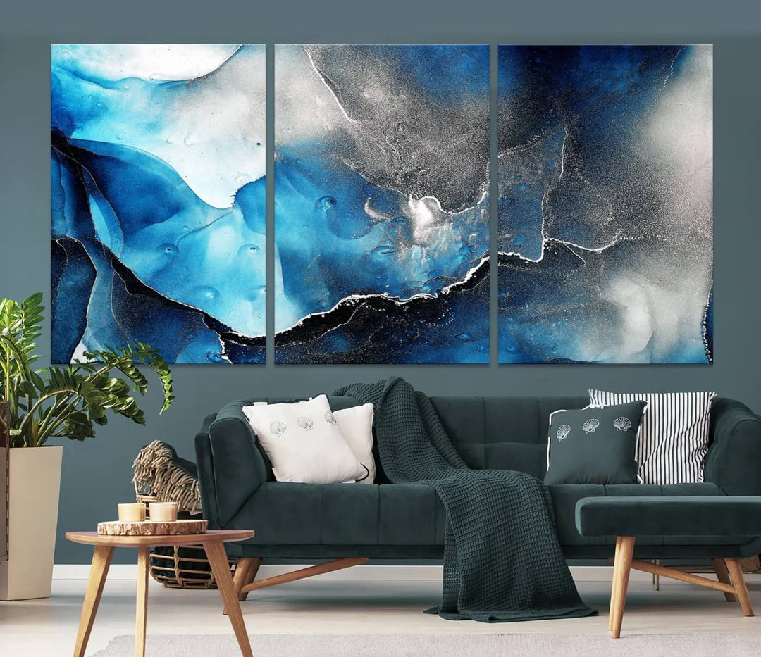 The Blue and Black Marble Fluid Effect Wall Art Abstract Canvas Prints feature three dynamic swirling patterns in blue, black, and white. Crafted on museum-quality canvases and enhanced with a UV-protective coating, these prints maintain their vibrant allure over time.