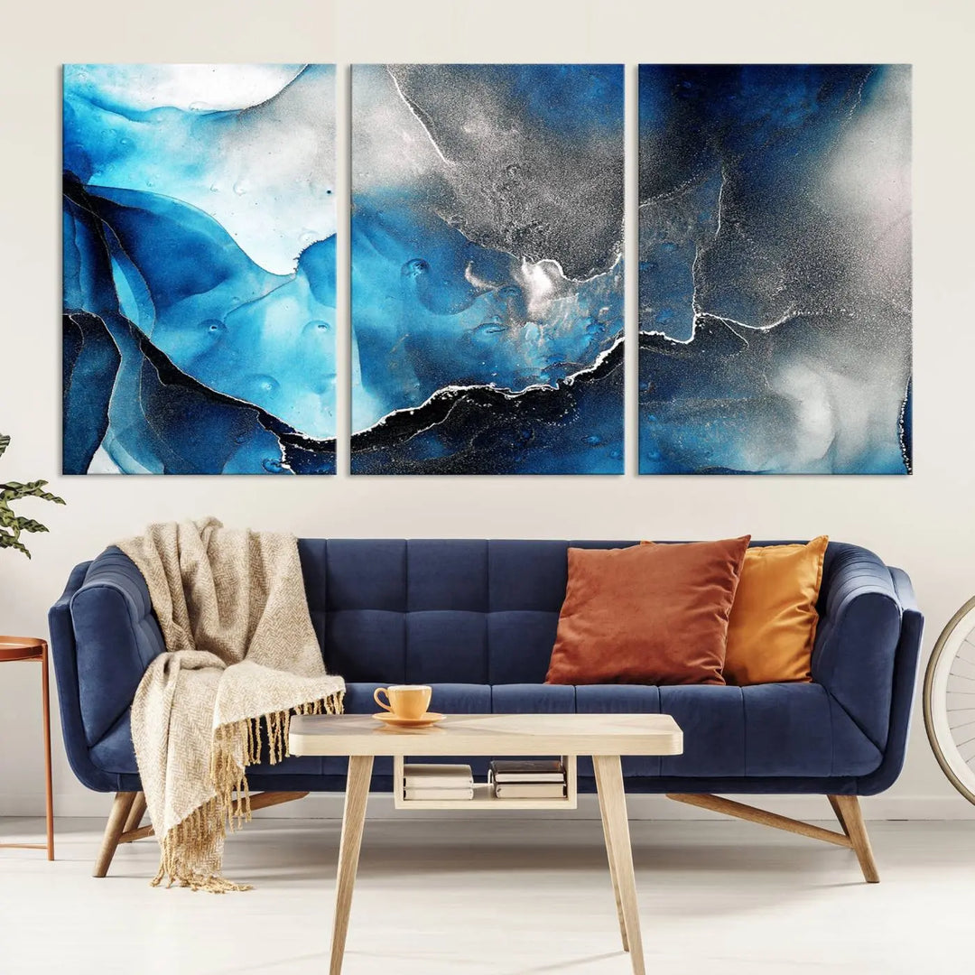 The Blue and Black Marble Fluid Effect Wall Art Abstract Canvas Prints feature three dynamic swirling patterns in blue, black, and white. Crafted on museum-quality canvases and enhanced with a UV-protective coating, these prints maintain their vibrant allure over time.