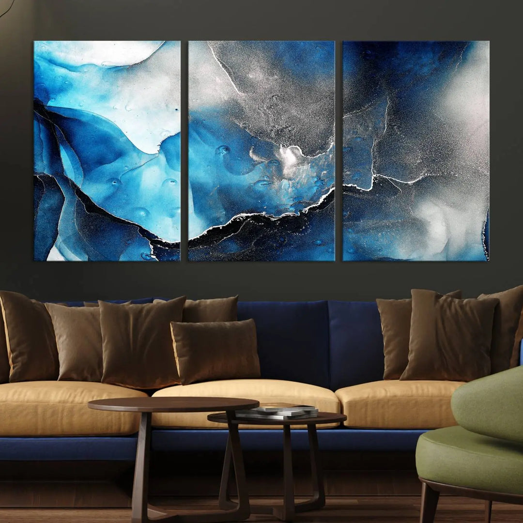 The Blue and Black Marble Fluid Effect Wall Art Abstract Canvas Prints feature three dynamic swirling patterns in blue, black, and white. Crafted on museum-quality canvases and enhanced with a UV-protective coating, these prints maintain their vibrant allure over time.