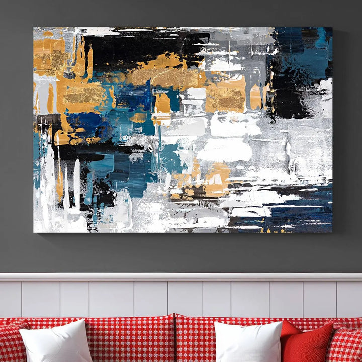 The Blue and Gold Abstract Canvas Wall Art – a triptych modern painting that's framed and ready to hang – features captivating brush strokes in blue, gold, black, and white to enhance the living room decor.