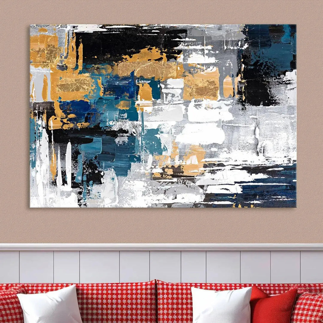 The Blue and Gold Abstract Canvas Wall Art – a triptych modern painting that's framed and ready to hang – features captivating brush strokes in blue, gold, black, and white to enhance the living room decor.