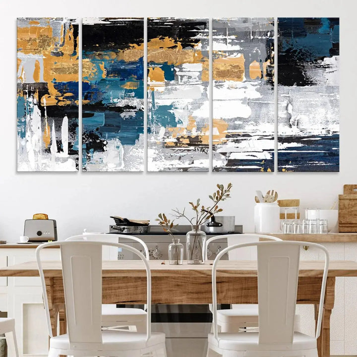 The Blue and Gold Abstract Canvas Wall Art – a triptych modern painting that's framed and ready to hang – features captivating brush strokes in blue, gold, black, and white to enhance the living room decor.