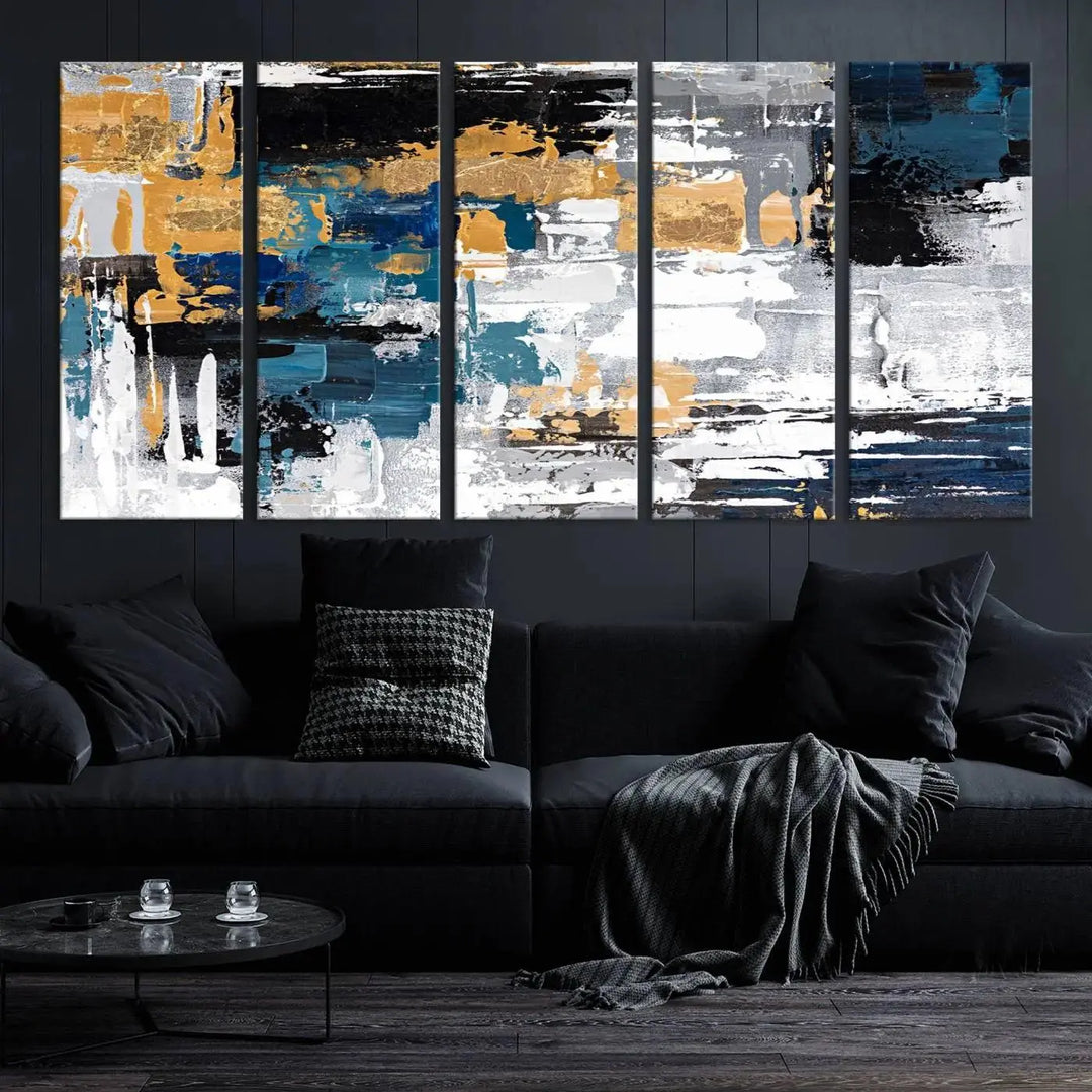 The Blue and Gold Abstract Canvas Wall Art – a triptych modern painting that's framed and ready to hang – features captivating brush strokes in blue, gold, black, and white to enhance the living room decor.