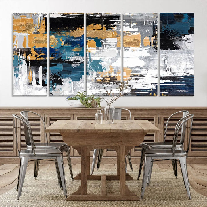 The Blue and Gold Abstract Canvas Wall Art – a triptych modern painting that's framed and ready to hang – features captivating brush strokes in blue, gold, black, and white to enhance the living room decor.