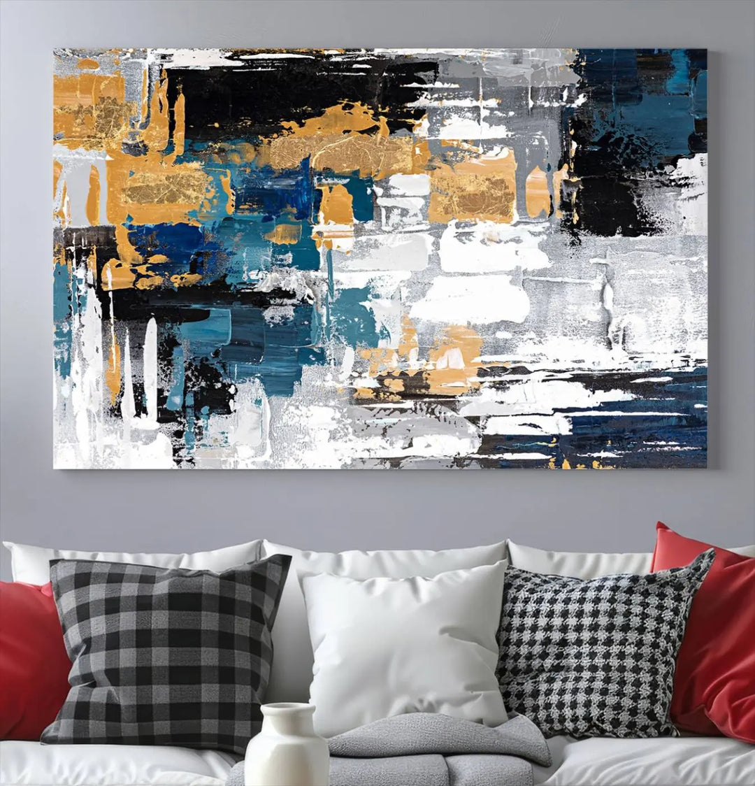 A sophisticated display of the Blue and Gold Abstract Canvas Wall Art – Triptych Modern Painting, featuring a captivating blend of blue, gold, black, and white tones, is elegantly framed and ready to hang.