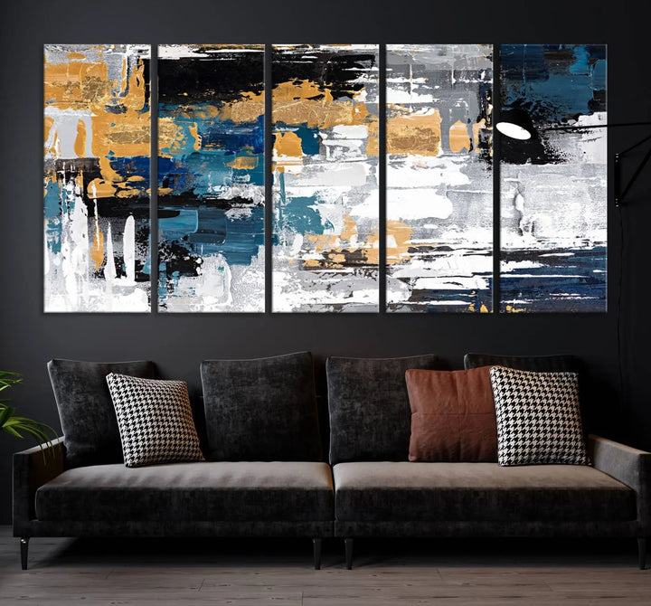 A sophisticated display of the Blue and Gold Abstract Canvas Wall Art – Triptych Modern Painting, featuring a captivating blend of blue, gold, black, and white tones, is elegantly framed and ready to hang.