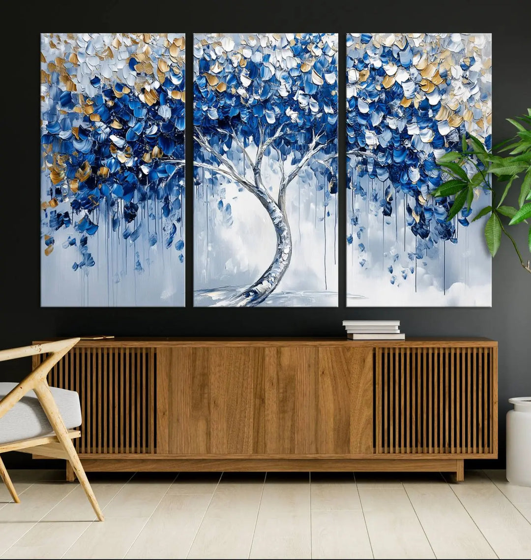 A framed canvas print of the Blue and Gold Abstract Tree Wall Art, depicting a modern Tree of Life painting, graces the dark wall, infusing the space with contemporary design and elegance.