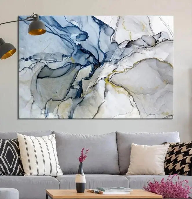 The "Blue and Gray Marble Fluid Effect Wall Art Abstract Canvas Wall Art Print" graces the dark wall, ready to hang. This triptych abstract art boasts a UV-protective coating for vibrant longevity in your space.