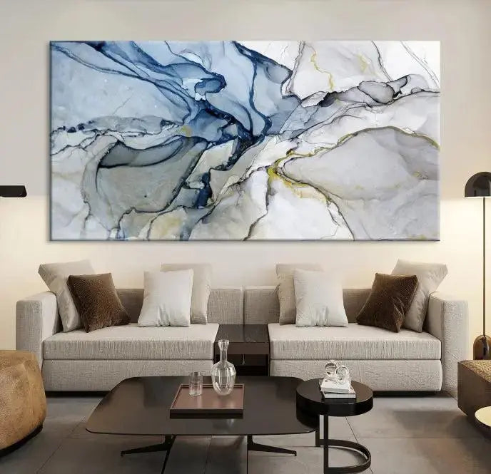 The "Blue and Gray Marble Fluid Effect Wall Art Abstract Canvas Wall Art Print" graces the dark wall, ready to hang. This triptych abstract art boasts a UV-protective coating for vibrant longevity in your space.