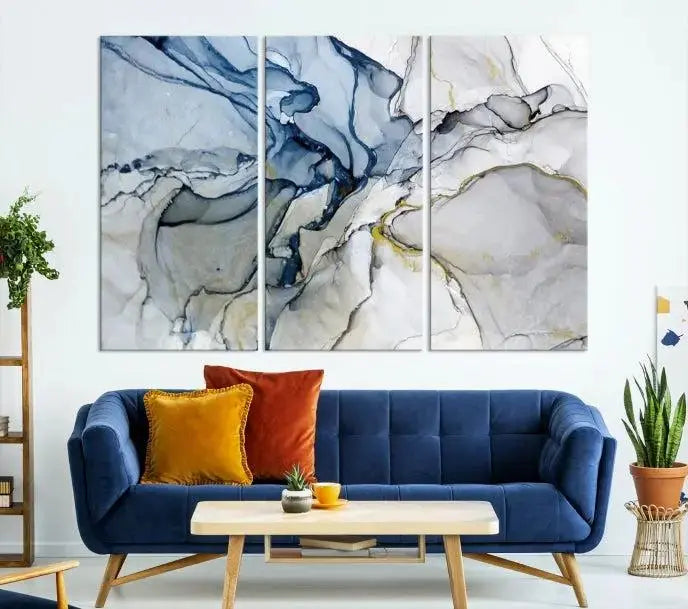 The "Blue and Gray Marble Fluid Effect Wall Art Abstract Canvas Wall Art Print" graces the dark wall, ready to hang. This triptych abstract art boasts a UV-protective coating for vibrant longevity in your space.