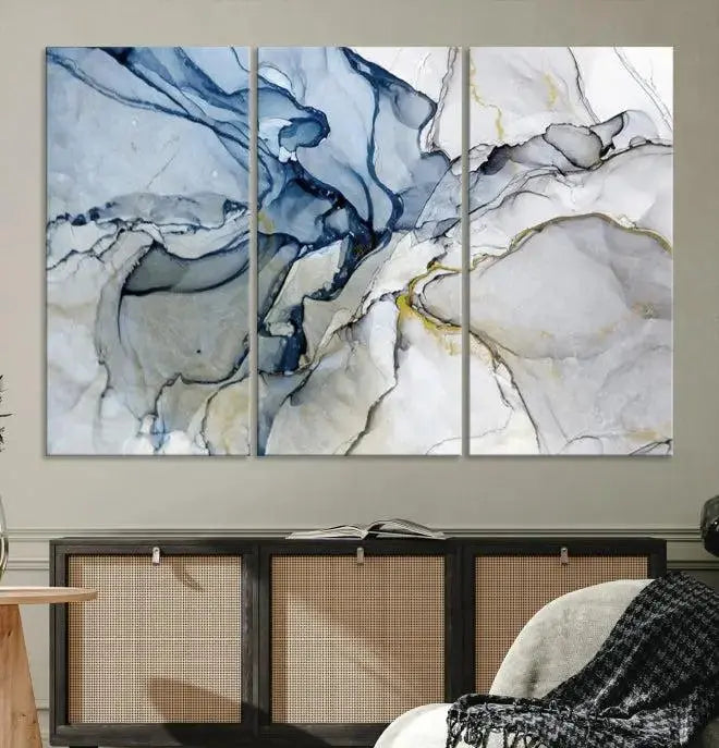 The "Blue and Gray Marble Fluid Effect Wall Art Abstract Canvas Wall Art Print" graces the dark wall, ready to hang. This triptych abstract art boasts a UV-protective coating for vibrant longevity in your space.