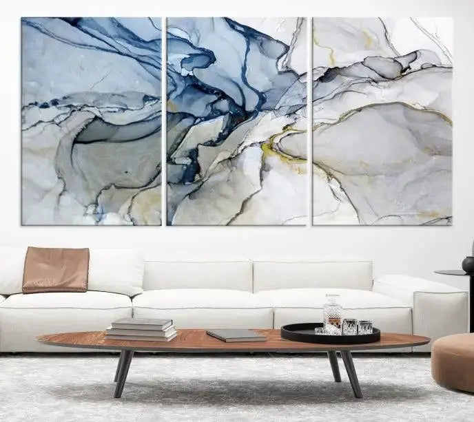 The "Blue and Gray Marble Fluid Effect Wall Art Abstract Canvas Wall Art Print" graces the dark wall, ready to hang. This triptych abstract art boasts a UV-protective coating for vibrant longevity in your space.