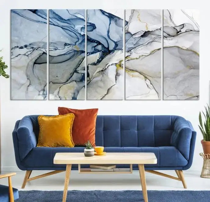 The "Blue and Gray Marble Fluid Effect Wall Art Abstract Canvas Wall Art Print" graces the dark wall, ready to hang. This triptych abstract art boasts a UV-protective coating for vibrant longevity in your space.