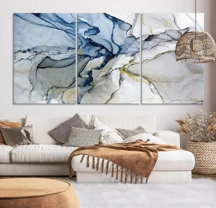 The "Blue and Gray Marble Fluid Effect Wall Art Abstract Canvas Wall Art Print" graces the dark wall, ready to hang. This triptych abstract art boasts a UV-protective coating for vibrant longevity in your space.