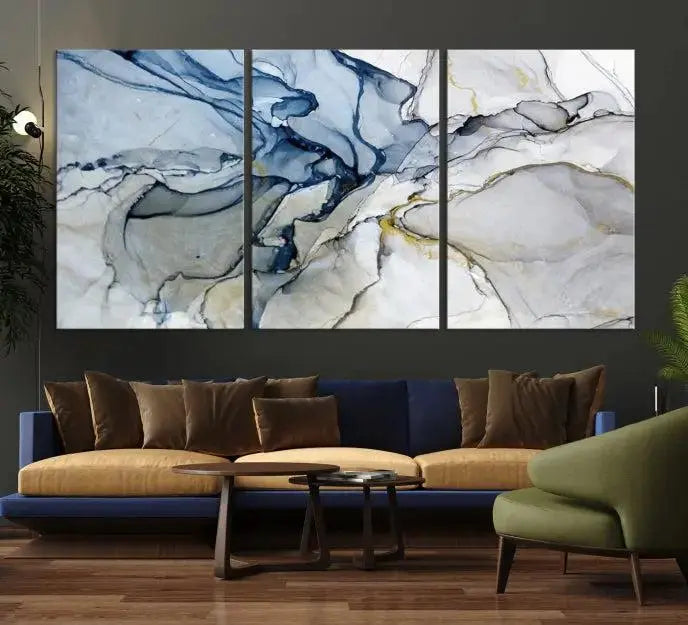 The "Blue and Gray Marble Fluid Effect Wall Art Abstract Canvas Wall Art Print" graces the dark wall, ready to hang. This triptych abstract art boasts a UV-protective coating for vibrant longevity in your space.