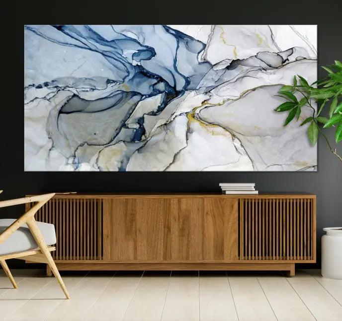 The "Blue and Gray Marble Fluid Effect Wall Art Abstract Canvas Wall Art Print" graces the dark wall, ready to hang. This triptych abstract art boasts a UV-protective coating for vibrant longevity in your space.