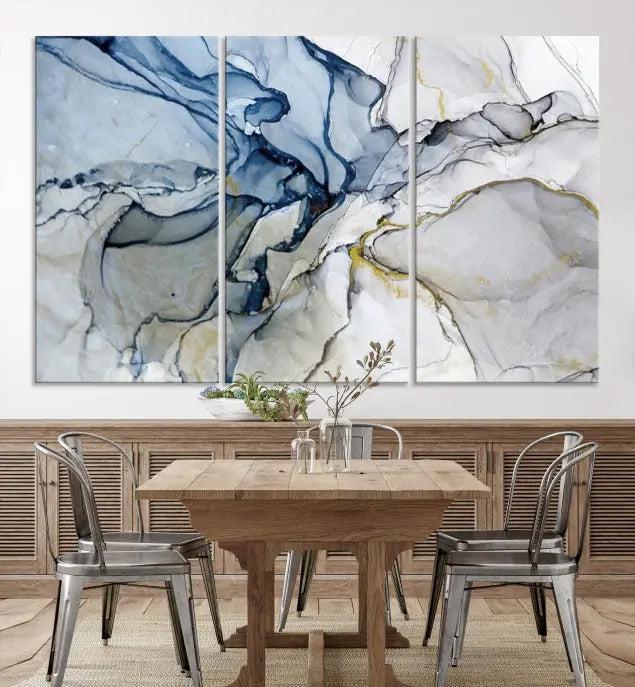 The "Blue and Gray Marble Fluid Effect Wall Art Abstract Canvas Wall Art Print" graces the dark wall, ready to hang. This triptych abstract art boasts a UV-protective coating for vibrant longevity in your space.