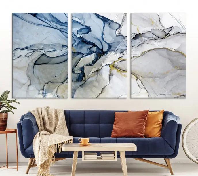 The "Blue and Gray Marble Fluid Effect Wall Art Abstract Canvas Wall Art Print" graces the dark wall, ready to hang. This triptych abstract art boasts a UV-protective coating for vibrant longevity in your space.