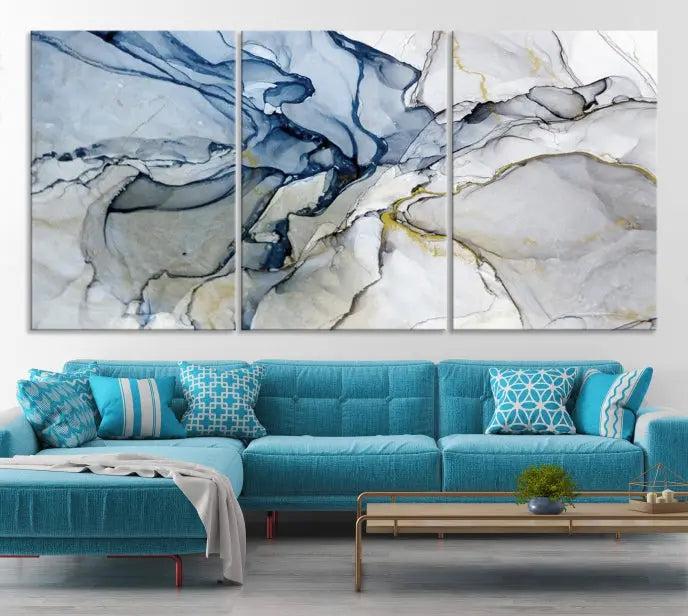 The "Blue and Gray Marble Fluid Effect Wall Art Abstract Canvas Wall Art Print" graces the dark wall, ready to hang. This triptych abstract art boasts a UV-protective coating for vibrant longevity in your space.