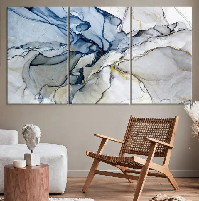 The "Blue and Gray Marble Fluid Effect Wall Art Abstract Canvas Wall Art Print" graces the dark wall, ready to hang. This triptych abstract art boasts a UV-protective coating for vibrant longevity in your space.