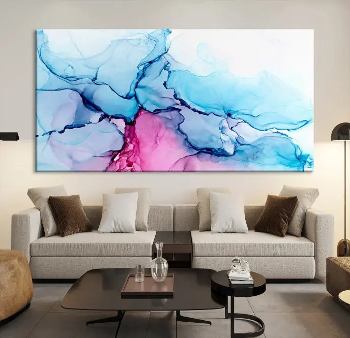 The "Blue and Pink Marble Fluid Effect Wall Art Abstract Canvas Wall Art Print" graces a dark wall. This exquisite piece is created on museum-quality polycotton canvas with a UV-protective coating.