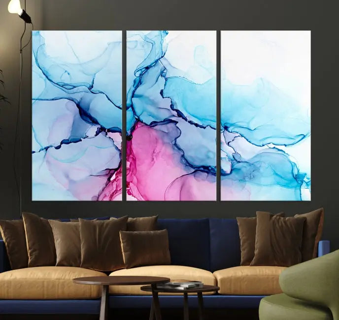 The "Blue and Pink Marble Fluid Effect Wall Art Abstract Canvas Wall Art Print" graces a dark wall. This exquisite piece is created on museum-quality polycotton canvas with a UV-protective coating.