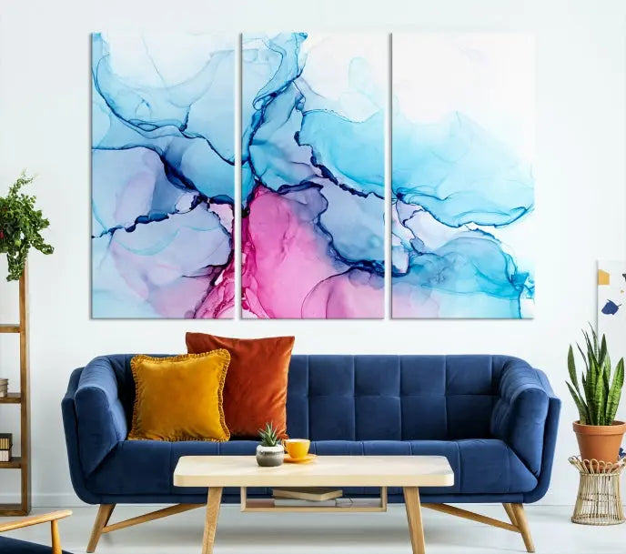 The "Blue and Pink Marble Fluid Effect Wall Art Abstract Canvas Wall Art Print" graces a dark wall. This exquisite piece is created on museum-quality polycotton canvas with a UV-protective coating.