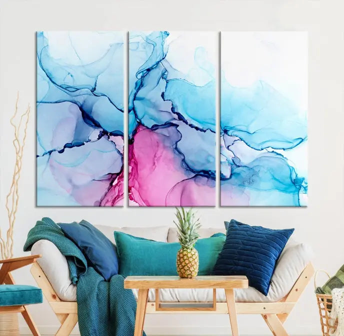 The "Blue and Pink Marble Fluid Effect Wall Art Abstract Canvas Wall Art Print" graces a dark wall. This exquisite piece is created on museum-quality polycotton canvas with a UV-protective coating.