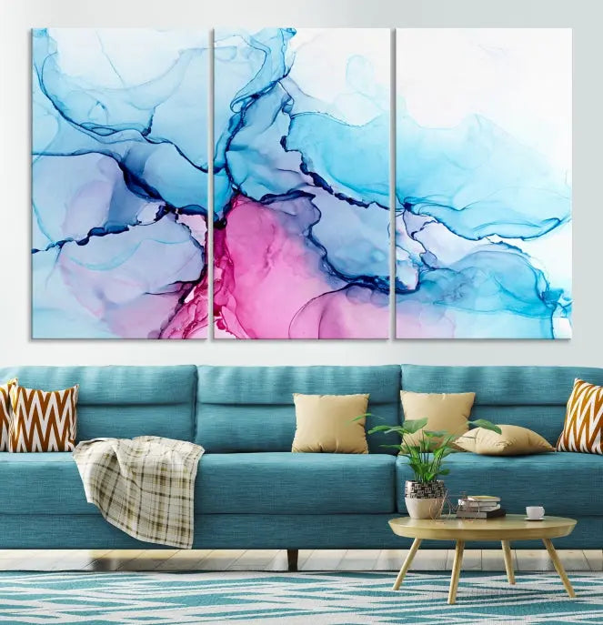 The "Blue and Pink Marble Fluid Effect Wall Art Abstract Canvas Wall Art Print" graces a dark wall. This exquisite piece is created on museum-quality polycotton canvas with a UV-protective coating.