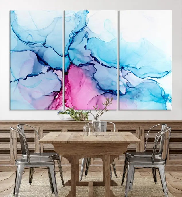 The "Blue and Pink Marble Fluid Effect Wall Art Abstract Canvas Wall Art Print" graces a dark wall. This exquisite piece is created on museum-quality polycotton canvas with a UV-protective coating.