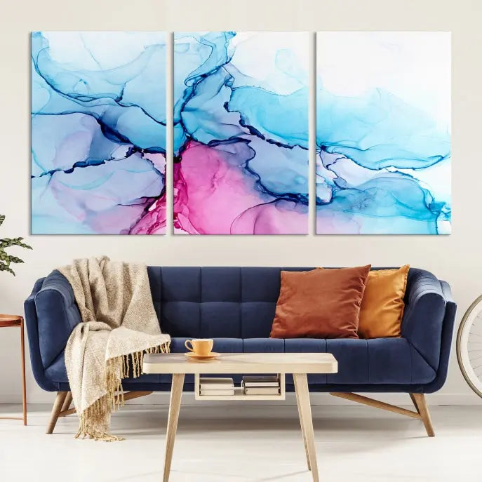 The "Blue and Pink Marble Fluid Effect Wall Art Abstract Canvas Wall Art Print" graces a dark wall. This exquisite piece is created on museum-quality polycotton canvas with a UV-protective coating.