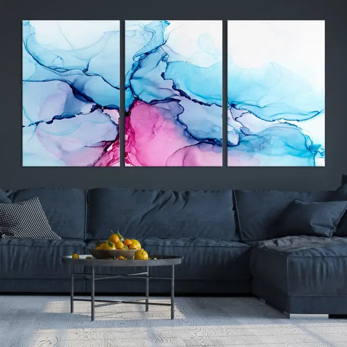 The "Blue and Pink Marble Fluid Effect Wall Art Abstract Canvas Wall Art Print" graces a dark wall. This exquisite piece is created on museum-quality polycotton canvas with a UV-protective coating.