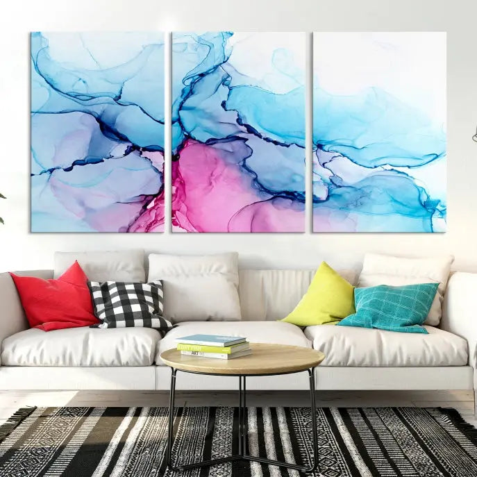 The "Blue and Pink Marble Fluid Effect Wall Art Abstract Canvas Wall Art Print" graces a dark wall. This exquisite piece is created on museum-quality polycotton canvas with a UV-protective coating.