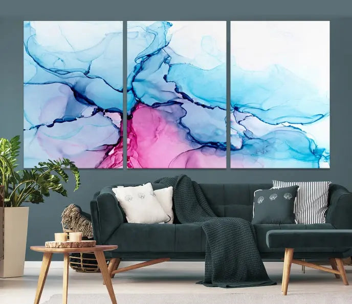 The "Blue and Pink Marble Fluid Effect Wall Art Abstract Canvas Wall Art Print" graces a dark wall. This exquisite piece is created on museum-quality polycotton canvas with a UV-protective coating.