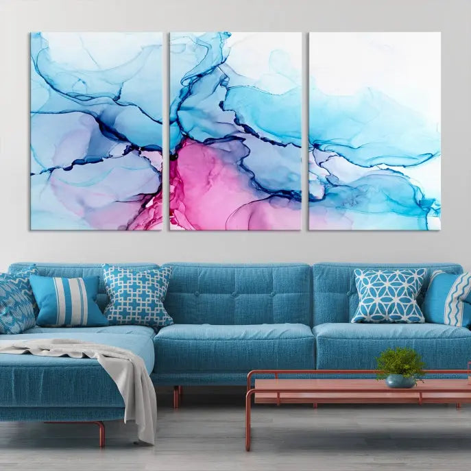 The "Blue and Pink Marble Fluid Effect Wall Art Abstract Canvas Wall Art Print" graces a dark wall. This exquisite piece is created on museum-quality polycotton canvas with a UV-protective coating.