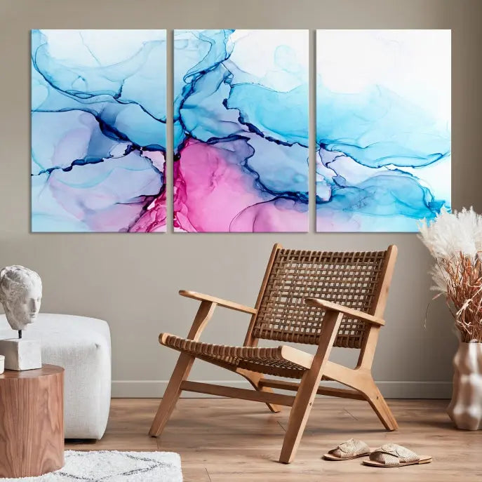 The "Blue and Pink Marble Fluid Effect Wall Art Abstract Canvas Wall Art Print" graces a dark wall. This exquisite piece is created on museum-quality polycotton canvas with a UV-protective coating.