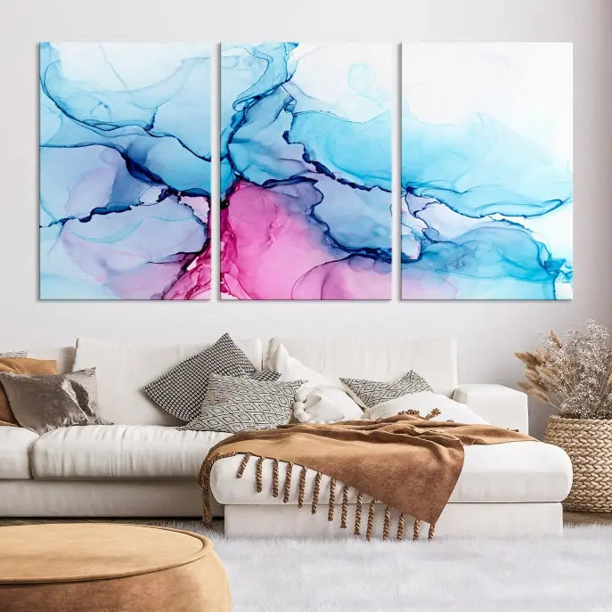 The "Blue and Pink Marble Fluid Effect Wall Art Abstract Canvas Wall Art Print" graces a dark wall. This exquisite piece is created on museum-quality polycotton canvas with a UV-protective coating.