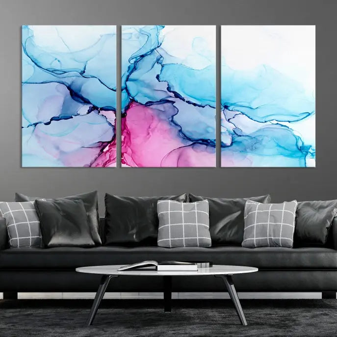 The "Blue and Pink Marble Fluid Effect Wall Art Abstract Canvas Wall Art Print" graces a dark wall. This exquisite piece is created on museum-quality polycotton canvas with a UV-protective coating.