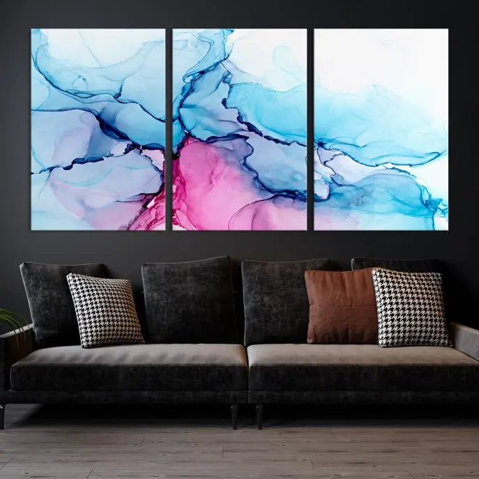 The "Blue and Pink Marble Fluid Effect Wall Art Abstract Canvas Wall Art Print" graces a dark wall. This exquisite piece is created on museum-quality polycotton canvas with a UV-protective coating.