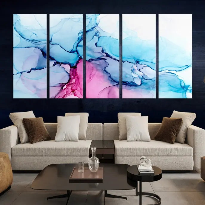 The "Blue and Pink Marble Fluid Effect Wall Art Abstract Canvas Wall Art Print" graces a dark wall. This exquisite piece is created on museum-quality polycotton canvas with a UV-protective coating.