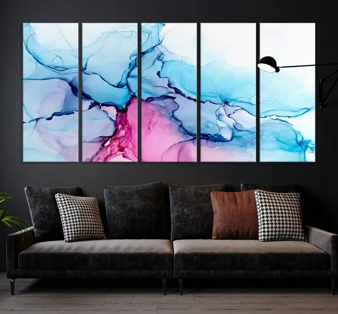 The "Blue and Pink Marble Fluid Effect Wall Art Abstract Canvas Wall Art Print" graces a dark wall. This exquisite piece is created on museum-quality polycotton canvas with a UV-protective coating.