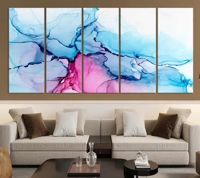 The "Blue and Pink Marble Fluid Effect Wall Art Abstract Canvas Wall Art Print" graces a dark wall. This exquisite piece is created on museum-quality polycotton canvas with a UV-protective coating.