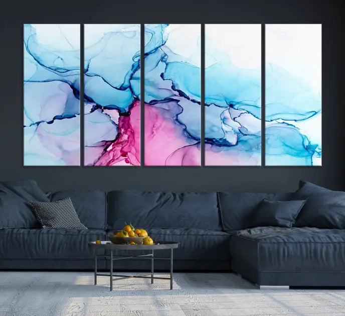 The "Blue and Pink Marble Fluid Effect Wall Art Abstract Canvas Wall Art Print" graces a dark wall. This exquisite piece is created on museum-quality polycotton canvas with a UV-protective coating.