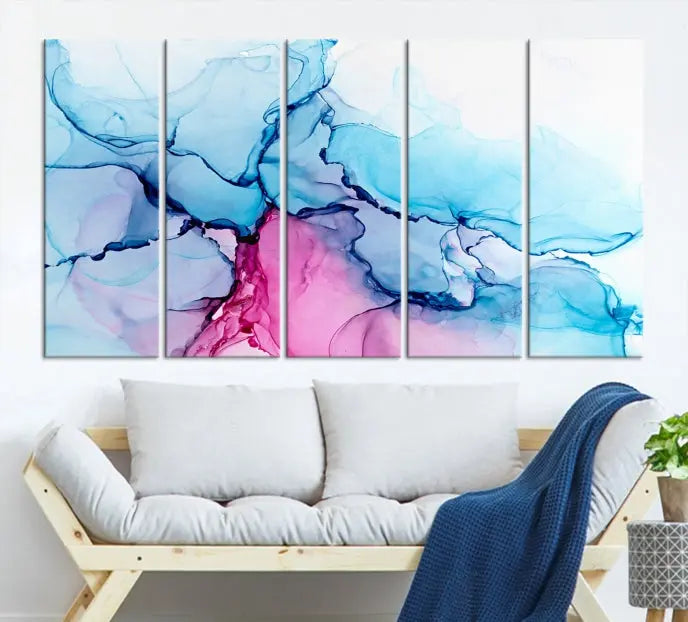 The "Blue and Pink Marble Fluid Effect Wall Art Abstract Canvas Wall Art Print" graces a dark wall. This exquisite piece is created on museum-quality polycotton canvas with a UV-protective coating.