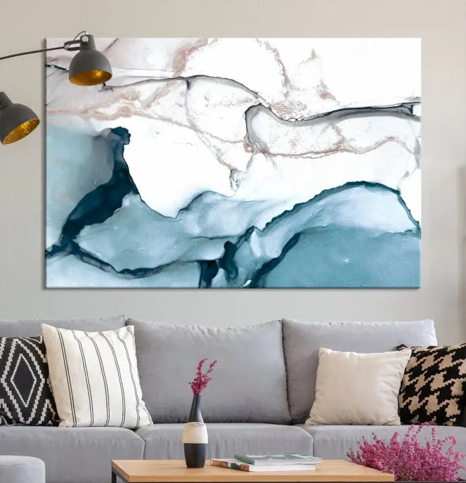 The modern living room features the Blue and Rose Gold Marble Fluid Effect Wall Art Abstract Canvas Art Print displayed on a gray wall.