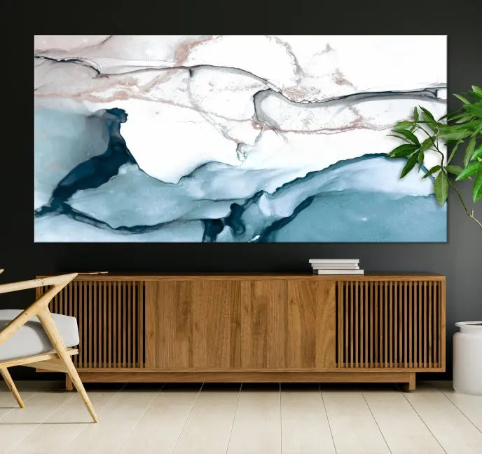 The modern living room features the Blue and Rose Gold Marble Fluid Effect Wall Art Abstract Canvas Art Print displayed on a gray wall.