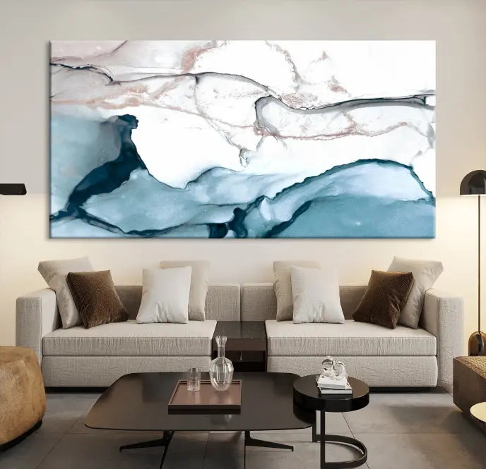 The modern living room features the Blue and Rose Gold Marble Fluid Effect Wall Art Abstract Canvas Art Print displayed on a gray wall.