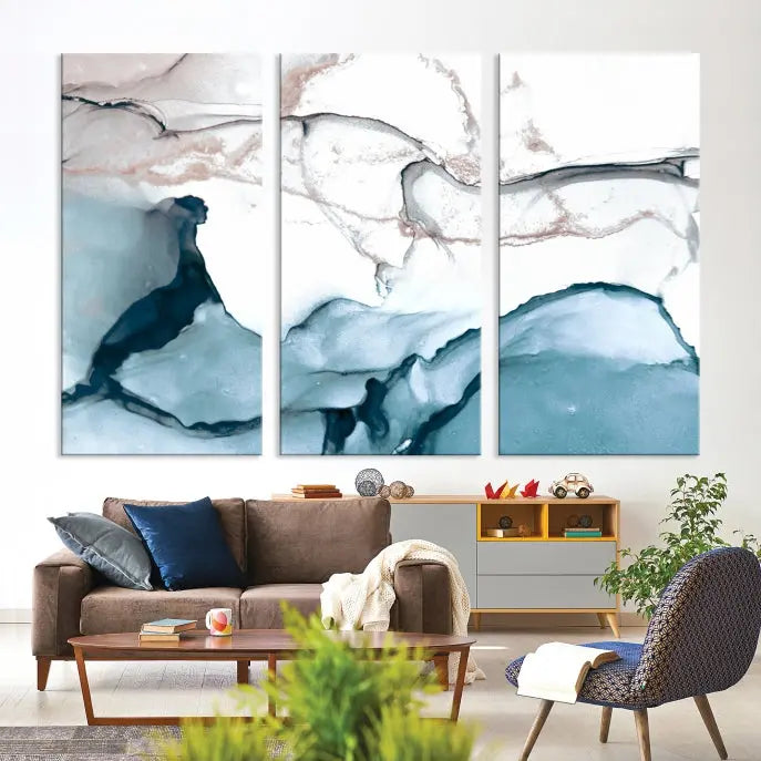 The modern living room features the Blue and Rose Gold Marble Fluid Effect Wall Art Abstract Canvas Art Print displayed on a gray wall.