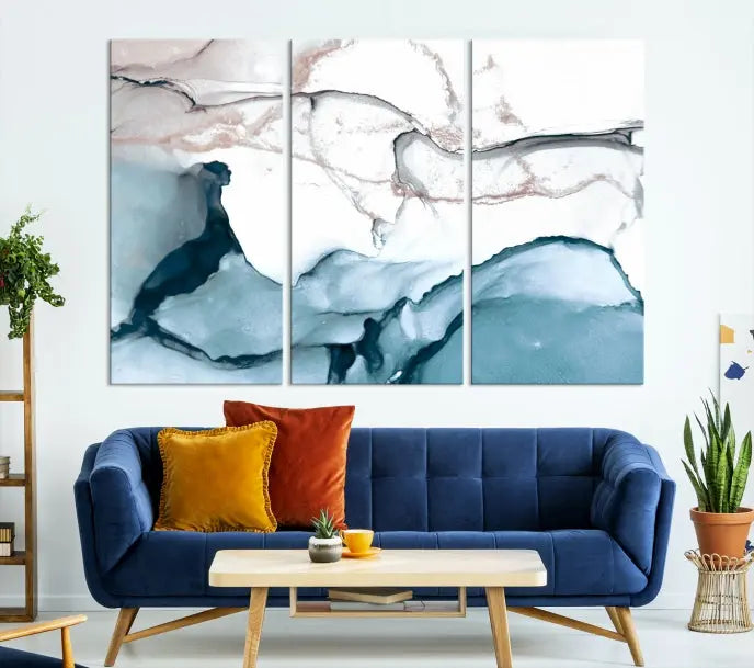 The modern living room features the Blue and Rose Gold Marble Fluid Effect Wall Art Abstract Canvas Art Print displayed on a gray wall.