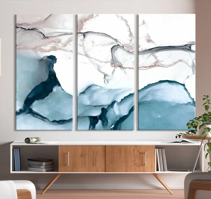 The modern living room features the Blue and Rose Gold Marble Fluid Effect Wall Art Abstract Canvas Art Print displayed on a gray wall.